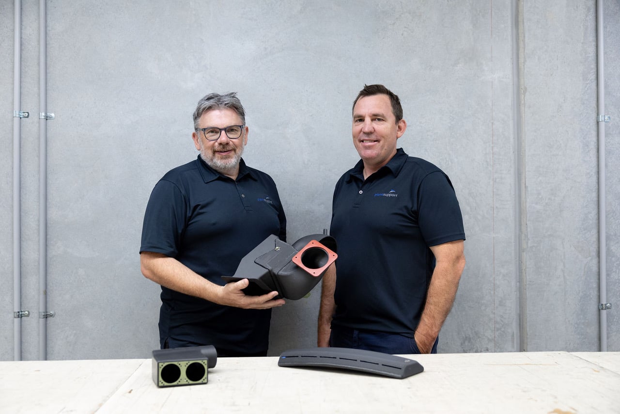 Plane Support Jason Hazell and Fraser Wright holding 3D printed Bell 214B cabin air conditioning ducting